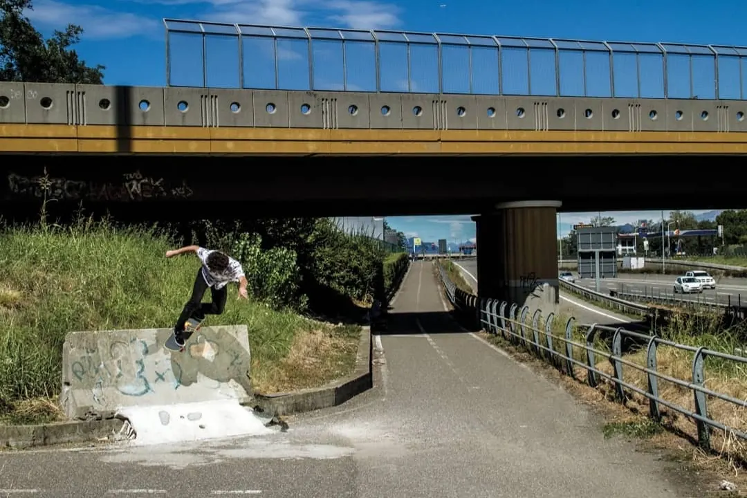 Ollie off a concrete barrier under a motorway bridge